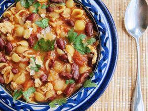 Closeup of Chicken Pasta e Fagiole with Smoked Paprika, served in a white and blue ceramic bowl.