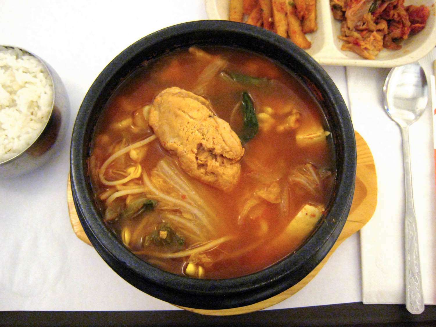 Overhead view of a clay pot of ahl jjigae