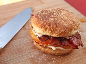 tomato and bacon breakfast sandwich on English muffin