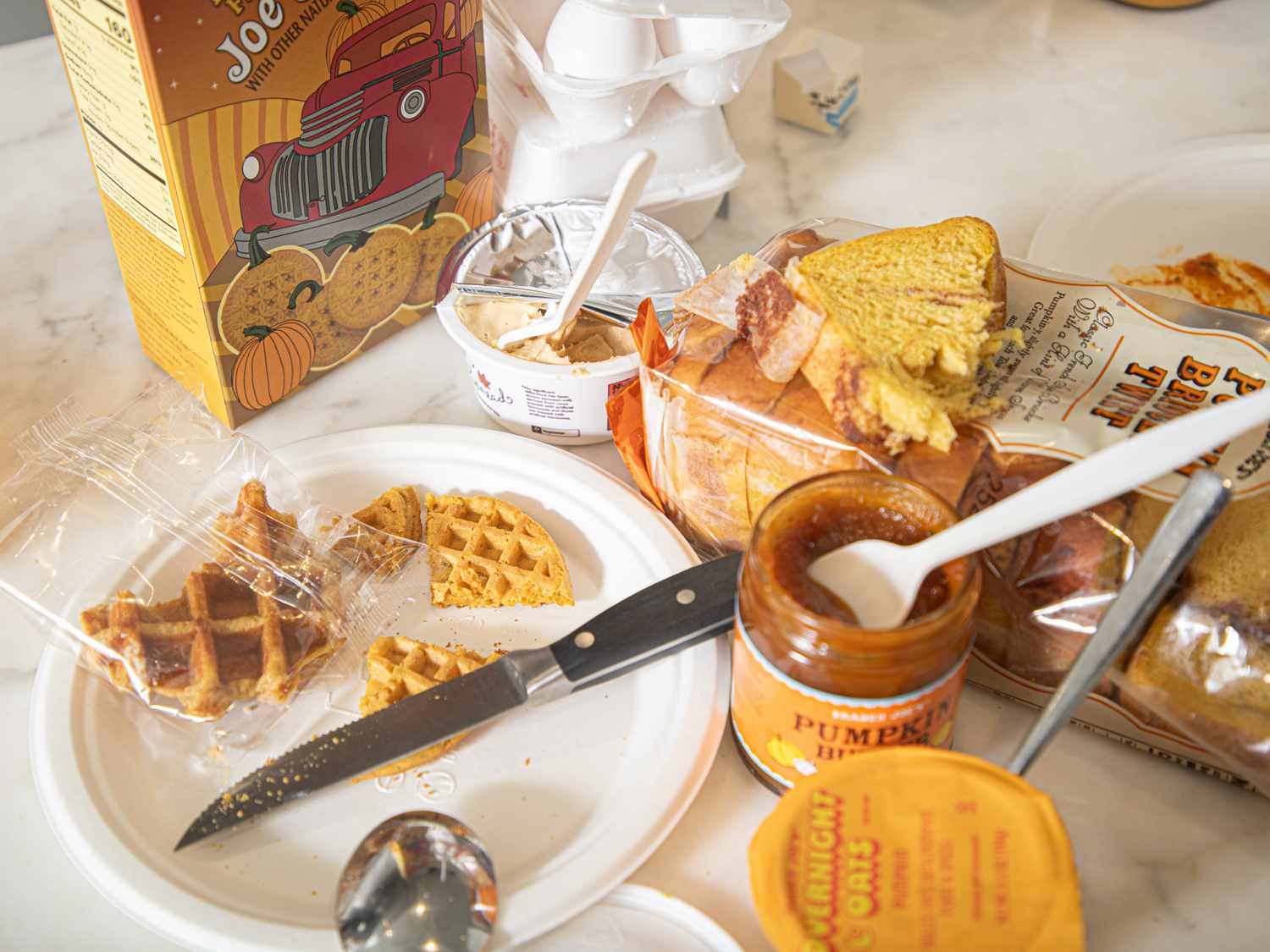 An assortment of pumpkinflavored products from Trader Joes displayed on a table
