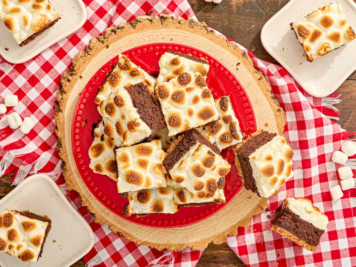Smores brownies with toasted marshmallows on a wooden platter