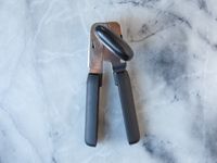The OXO can opener on a marble surface