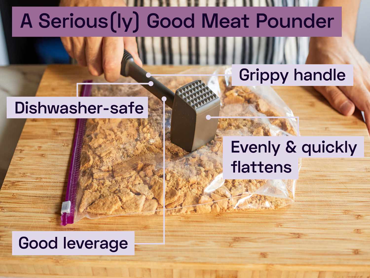 a hand using a mallet-style meat pounder to flatten graham crackers