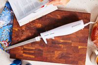 proctor silex electric knife on a wooden cutting board