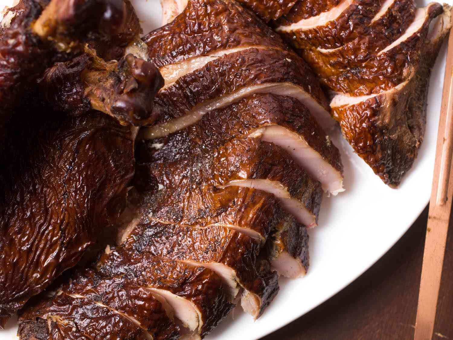 Sliced smoked turkey on a platter.