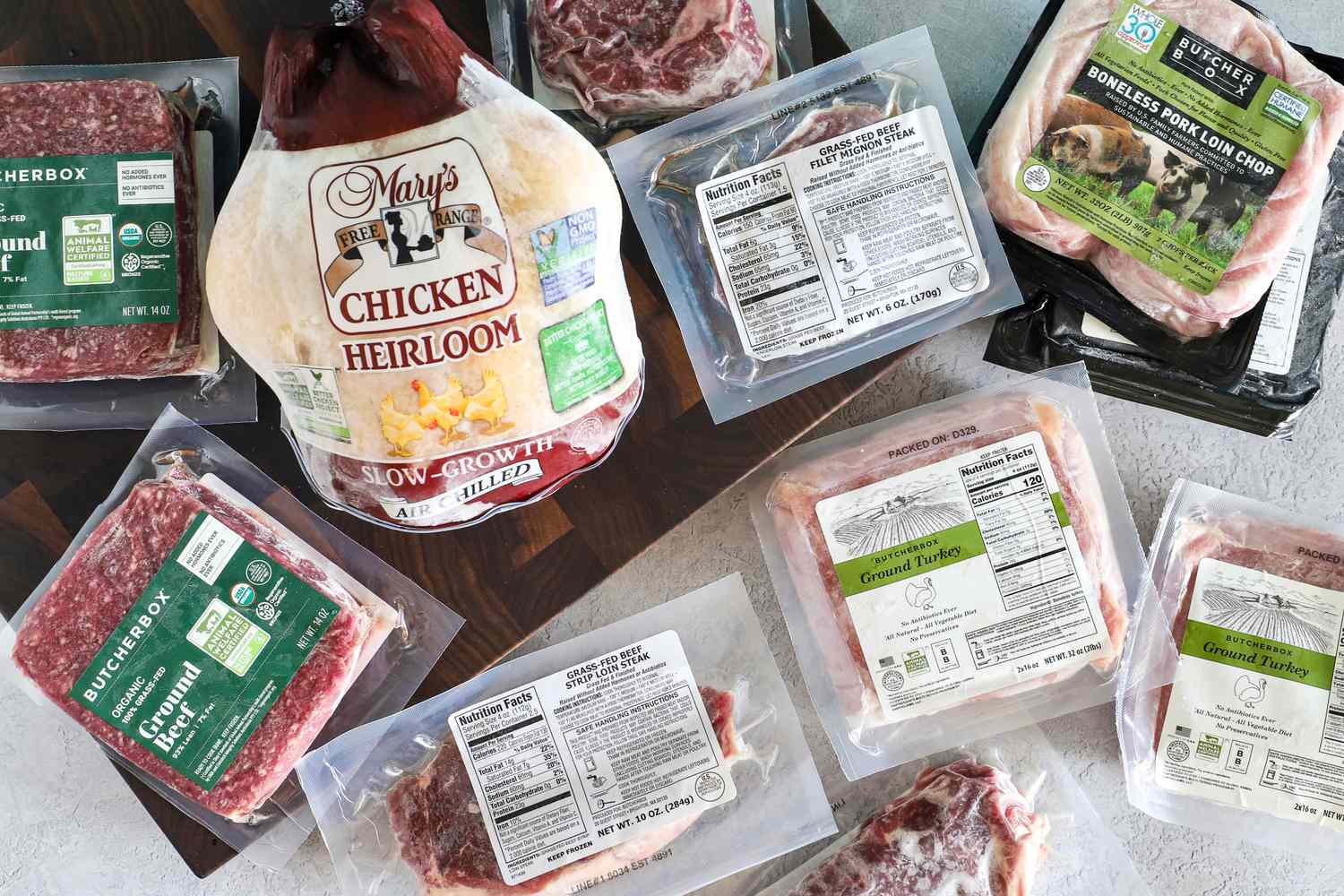 Various Butcherbox packaged meats including chicken beef turkey and pork displayed on a surface