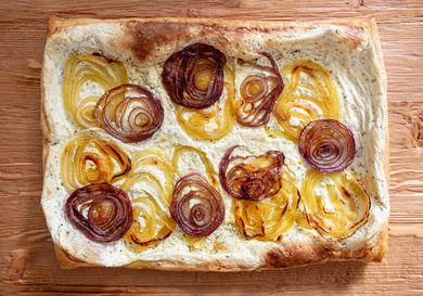 Baked tart with caramelized onion layers on a creamy base