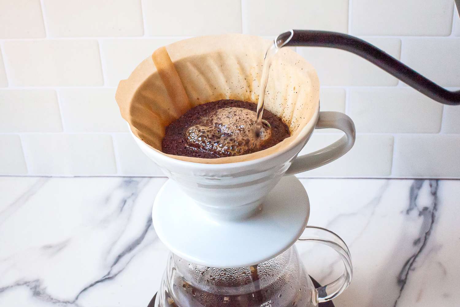 Pour-over coffee brewing in progress with water being poured onto the coffee grounds in the filter