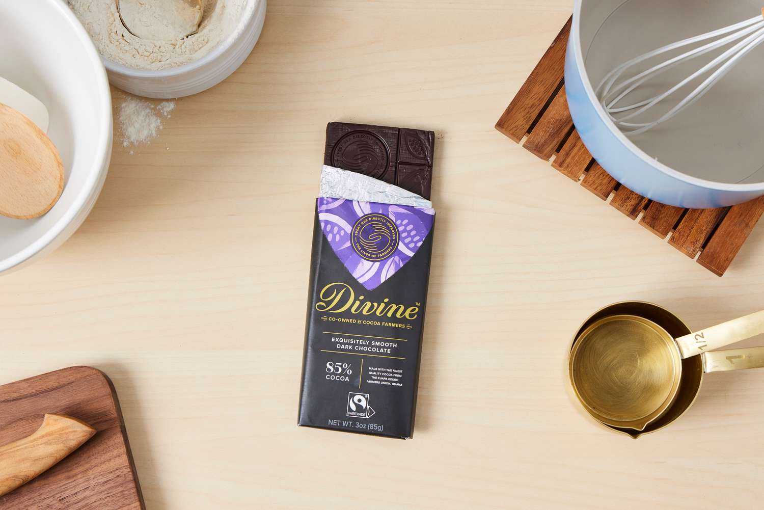 A partially unwrapped Divine extra-dark chocolate bar.