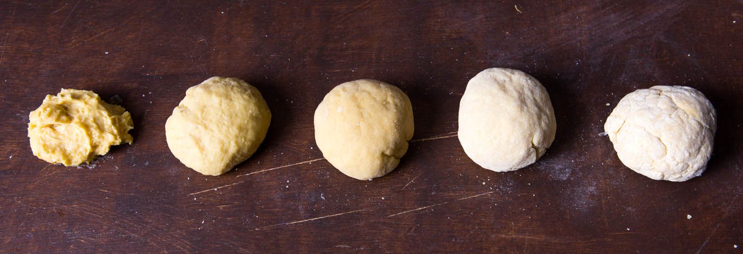 Five batches of pasta dough with various hydration levels, starting with four ounces of flour and increasing in half-ounce increments.
