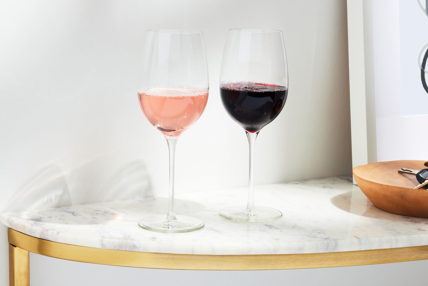 Two Libbey Signature Kentfield Estate All-Purpose Wine Glasses containing different wines on a marble counter