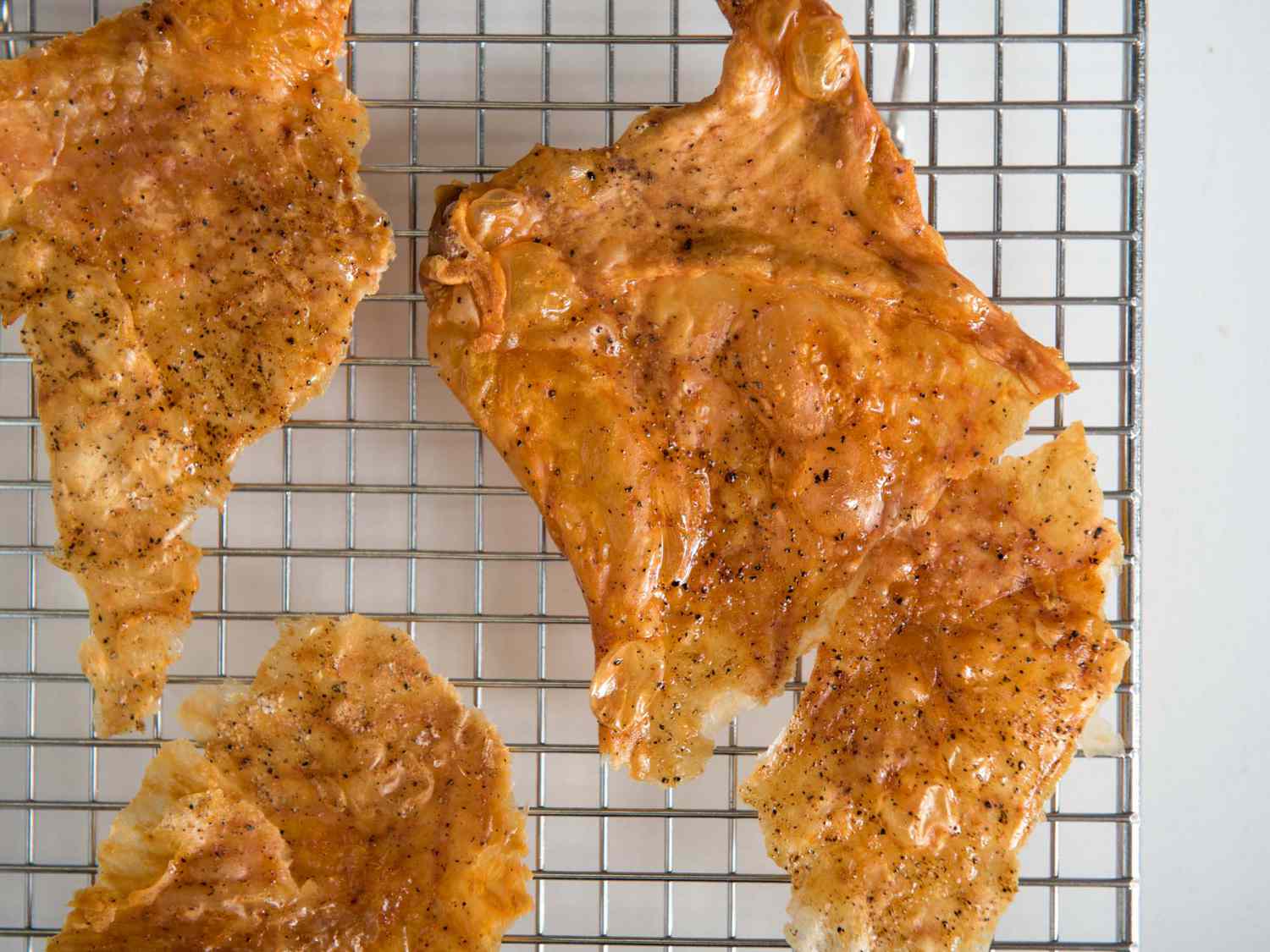 Crisp roasted turkey skin cooling on a wire rack.