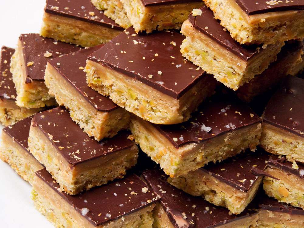 Close-up of a large pile of pistachio millionaire's shortbread with coriander butterscotch.