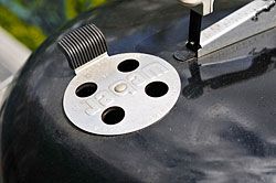 A grill vent on a Weber grill.