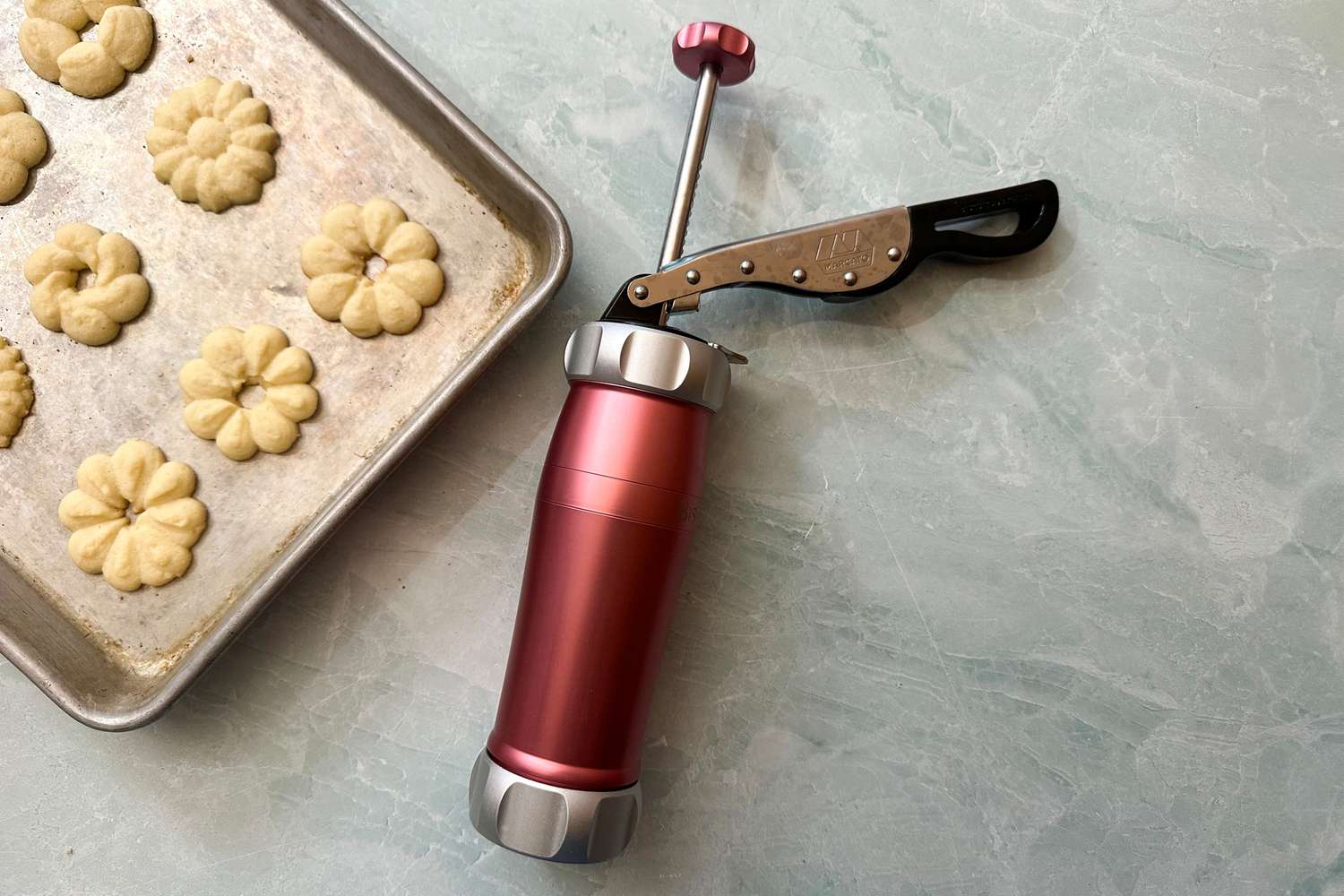 The Marcato Design Atlas Cookie Press next to a tray of cookies