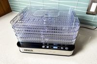 Nesco Digital 5 Rectangular Dehydrator with clear stackable trays on a kitchen counter