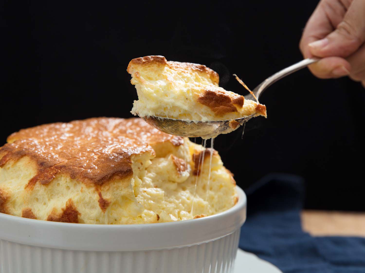 spoon dipping into cheese souffle