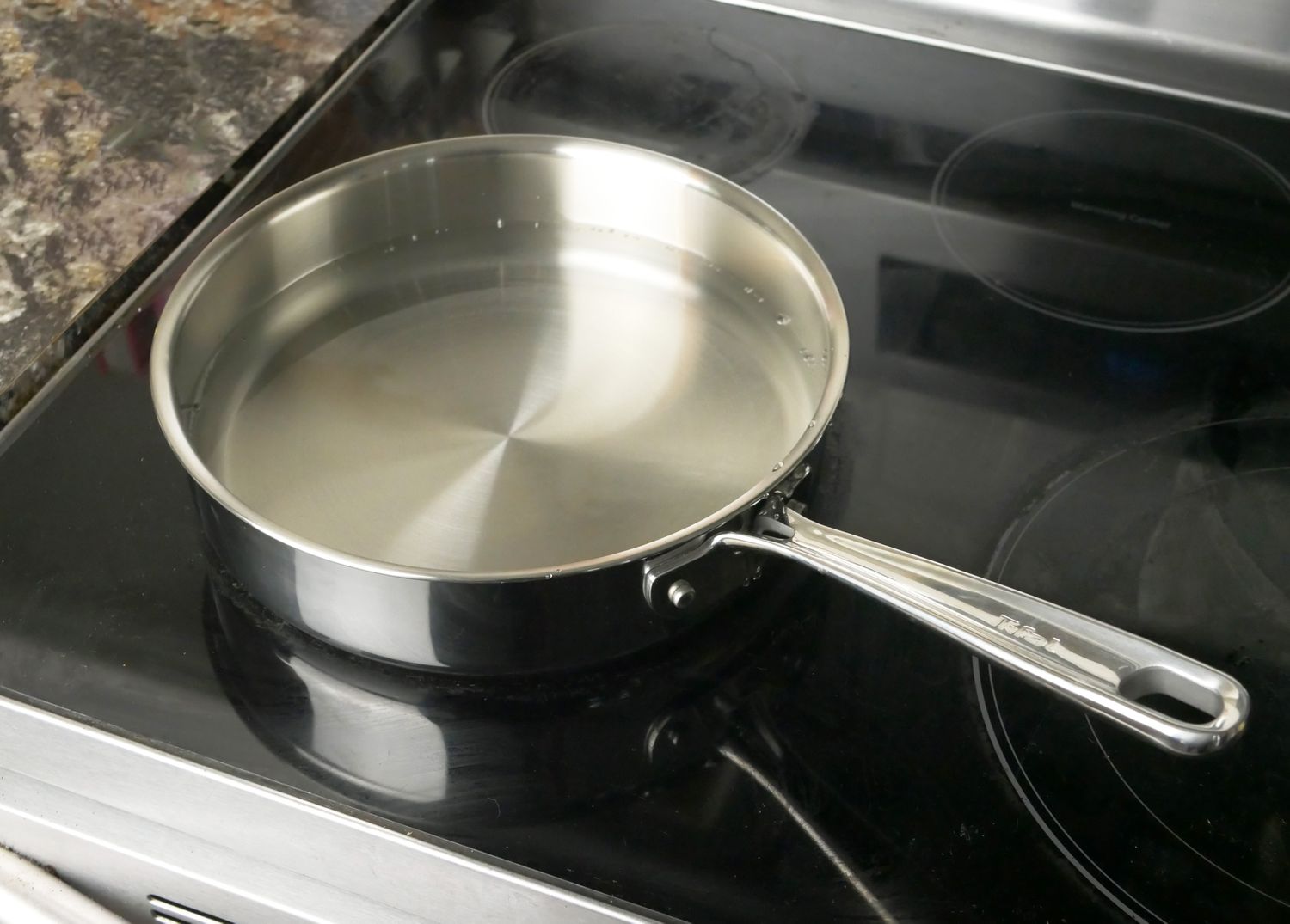 the t-fal saute pan on a glass stovetop