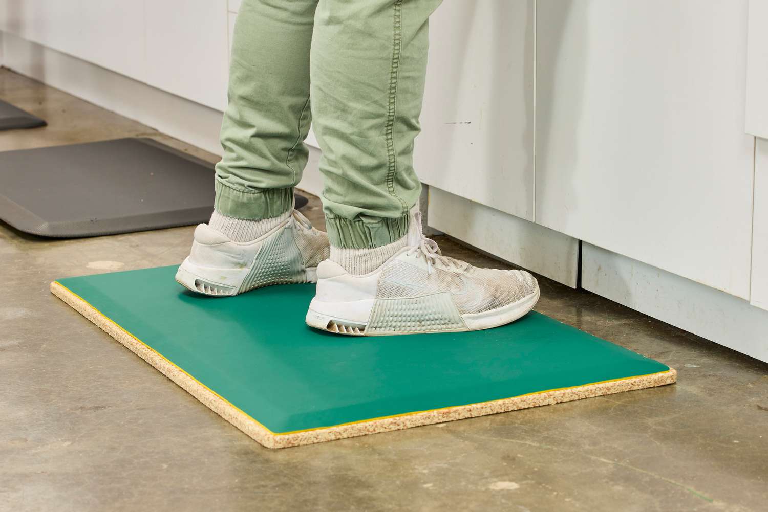A person stands on the Fulton Standing Mat