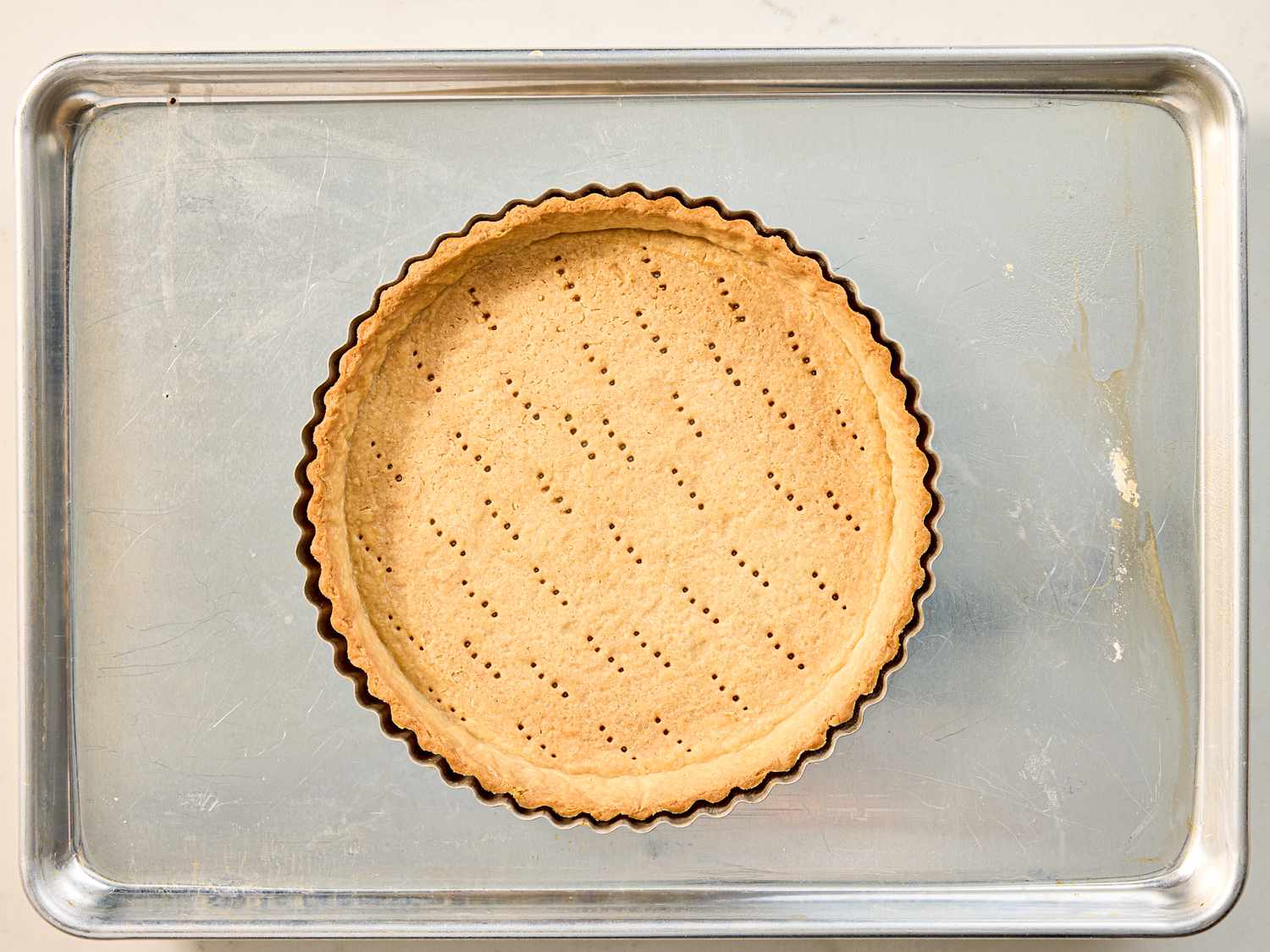 A baked tart crust on a baking tray