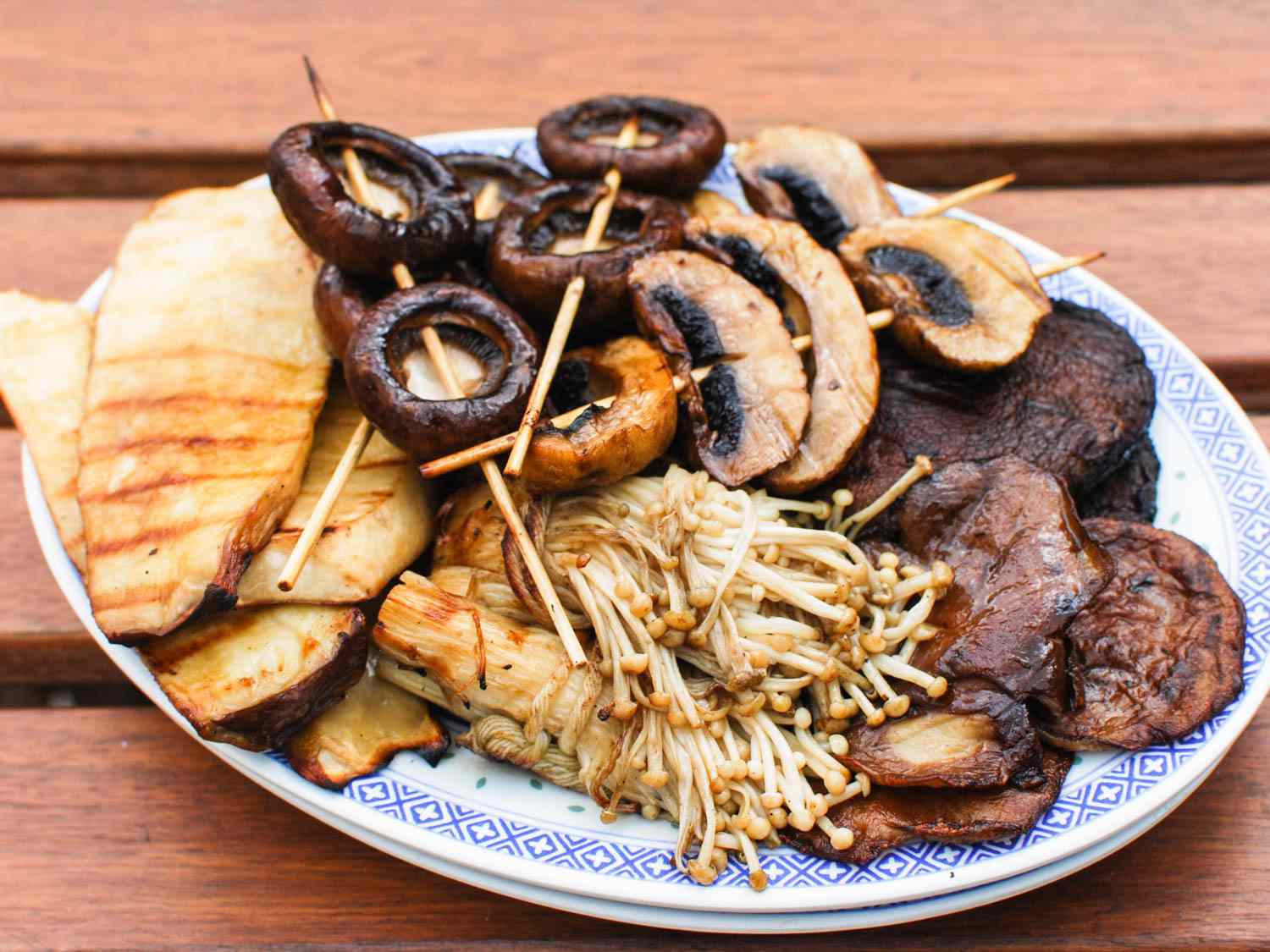 A variety of grilled mushrooms on a serving plate. 