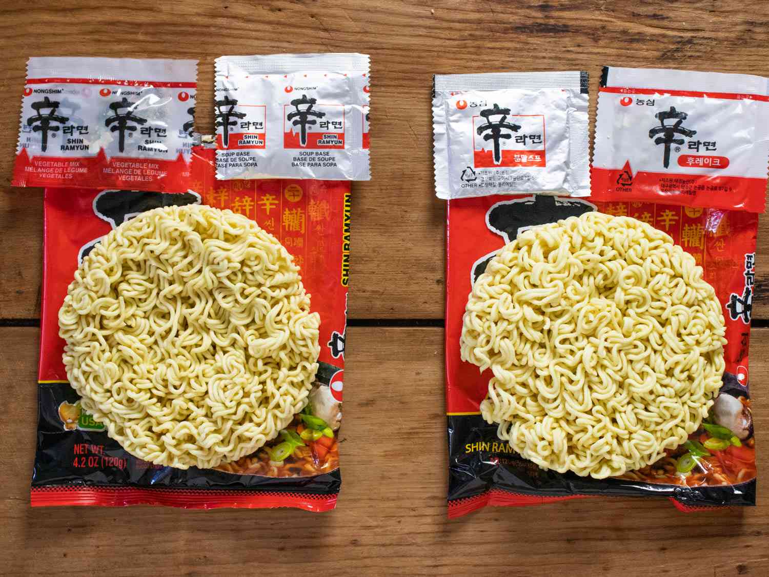 Unpackaged Shin Ramyun Red with components on display, Korean version on the right