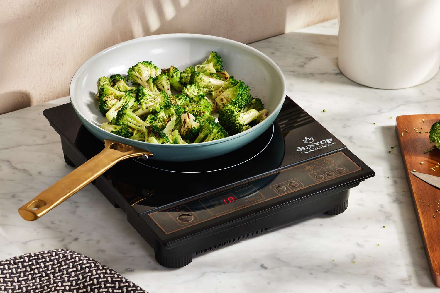 Broccoli cooking in a pan on the Duxtop BT-180G3 1800W Portable Induction Cooktop Countertop Burner