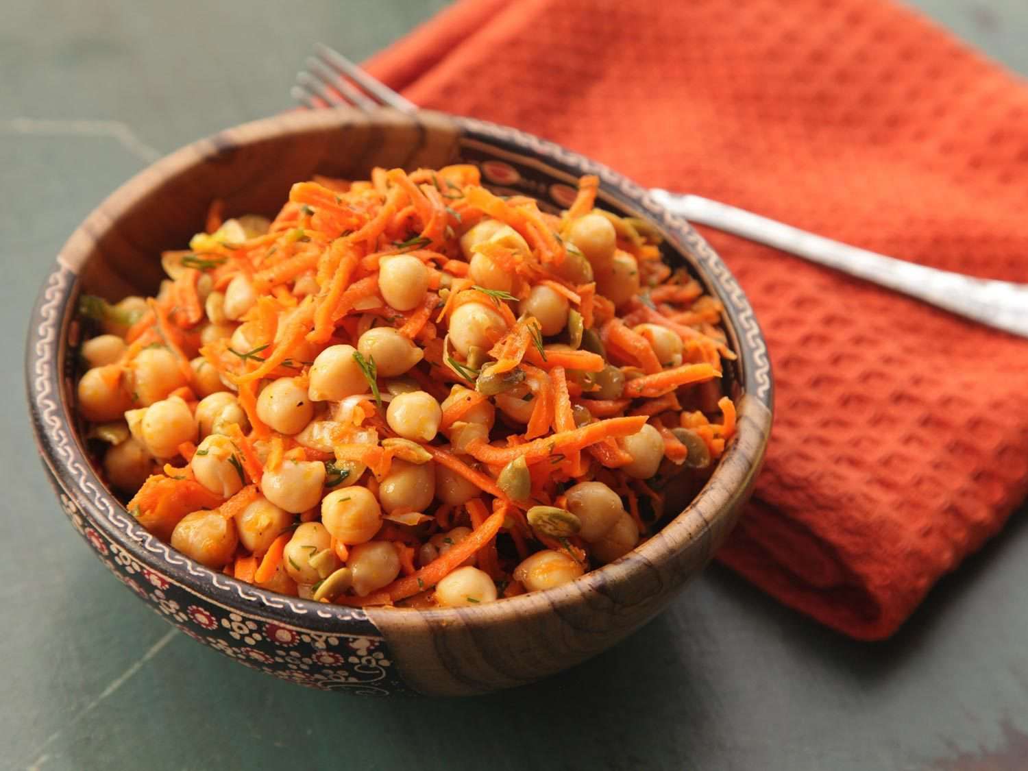 A bowl of Carrot and Chickpea Salad With Dill and Pumpkin Seeds.