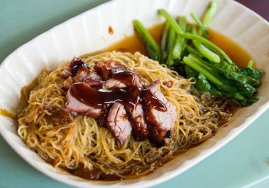 A white dish of wonton mee. 