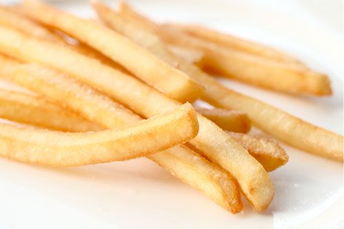 McDonald's french fries sitting on a white porcelain plate.
