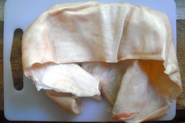 Pig skin on a cutting board. 