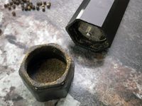 a closeup of the HexMill catch basin and grind adjuster on the bottom of the mill