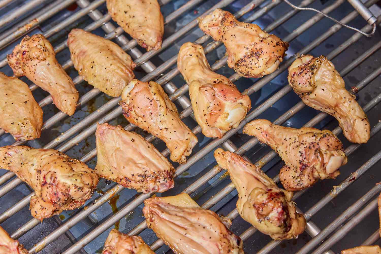 Chicken wings are cooked in the Yoder Smokers YS640S Pellet Grill