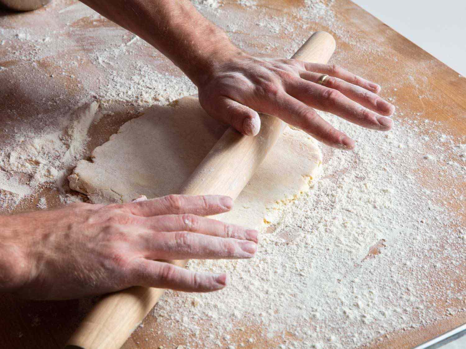 Rolling out pie dough for French onion soup tarte tatin.