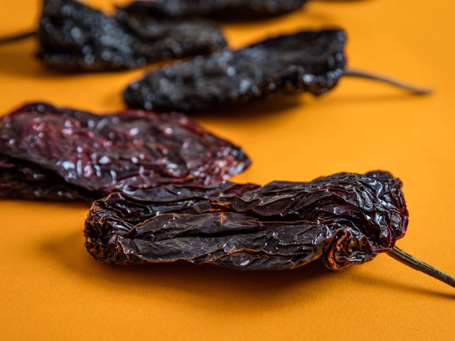 Close-up of wrinkly, purplish dried ancho chilies