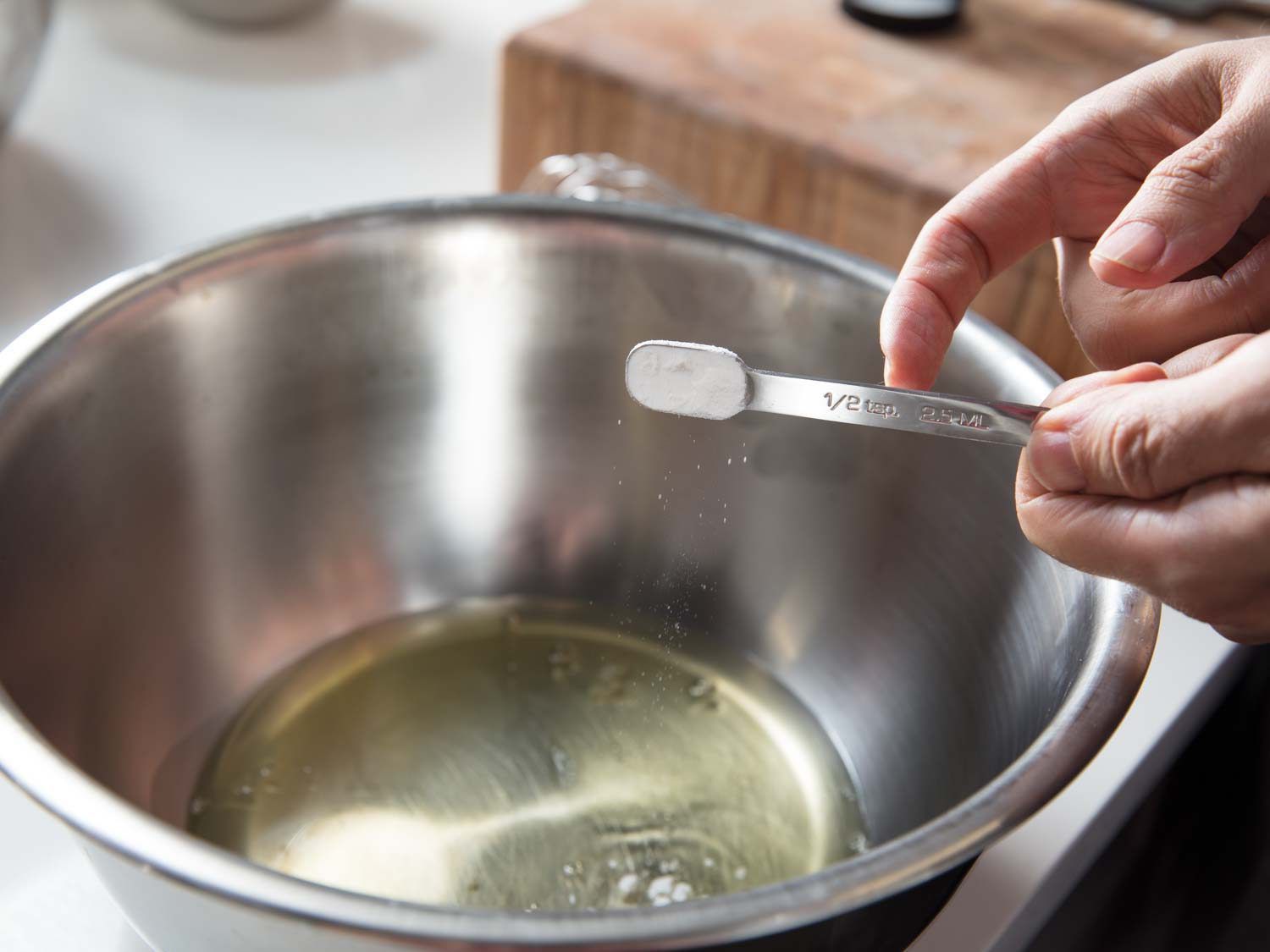 Adding cream of tartar to egg whites before beating.