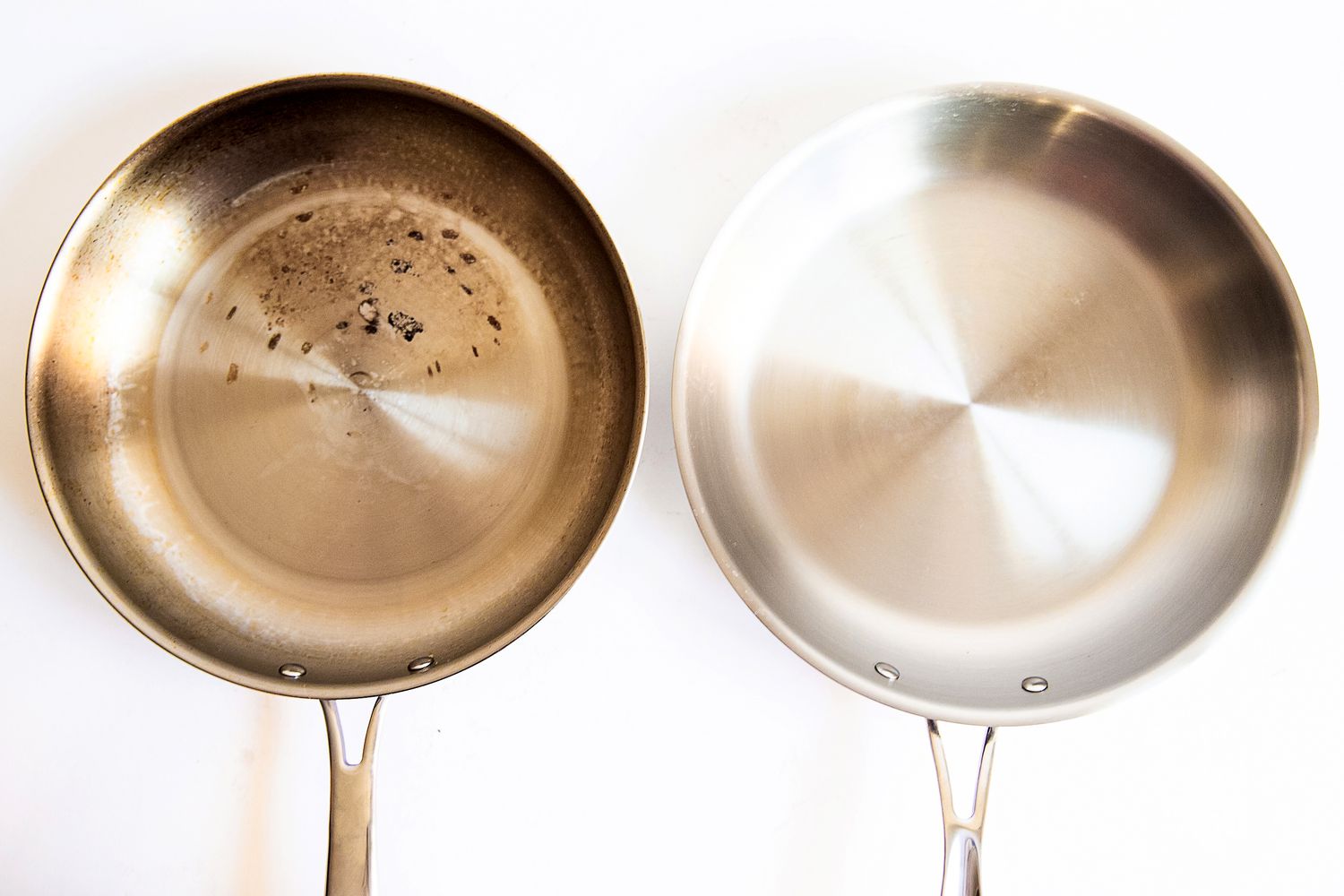 Two frying pans, one dirty with residue and one clean, displayed side by side