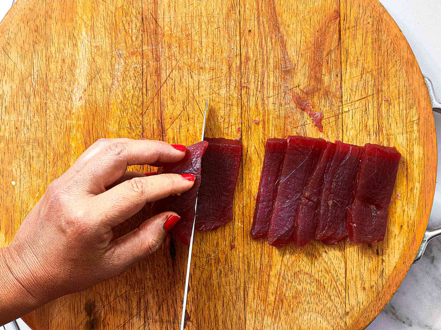 Overhead view of slicing tuna