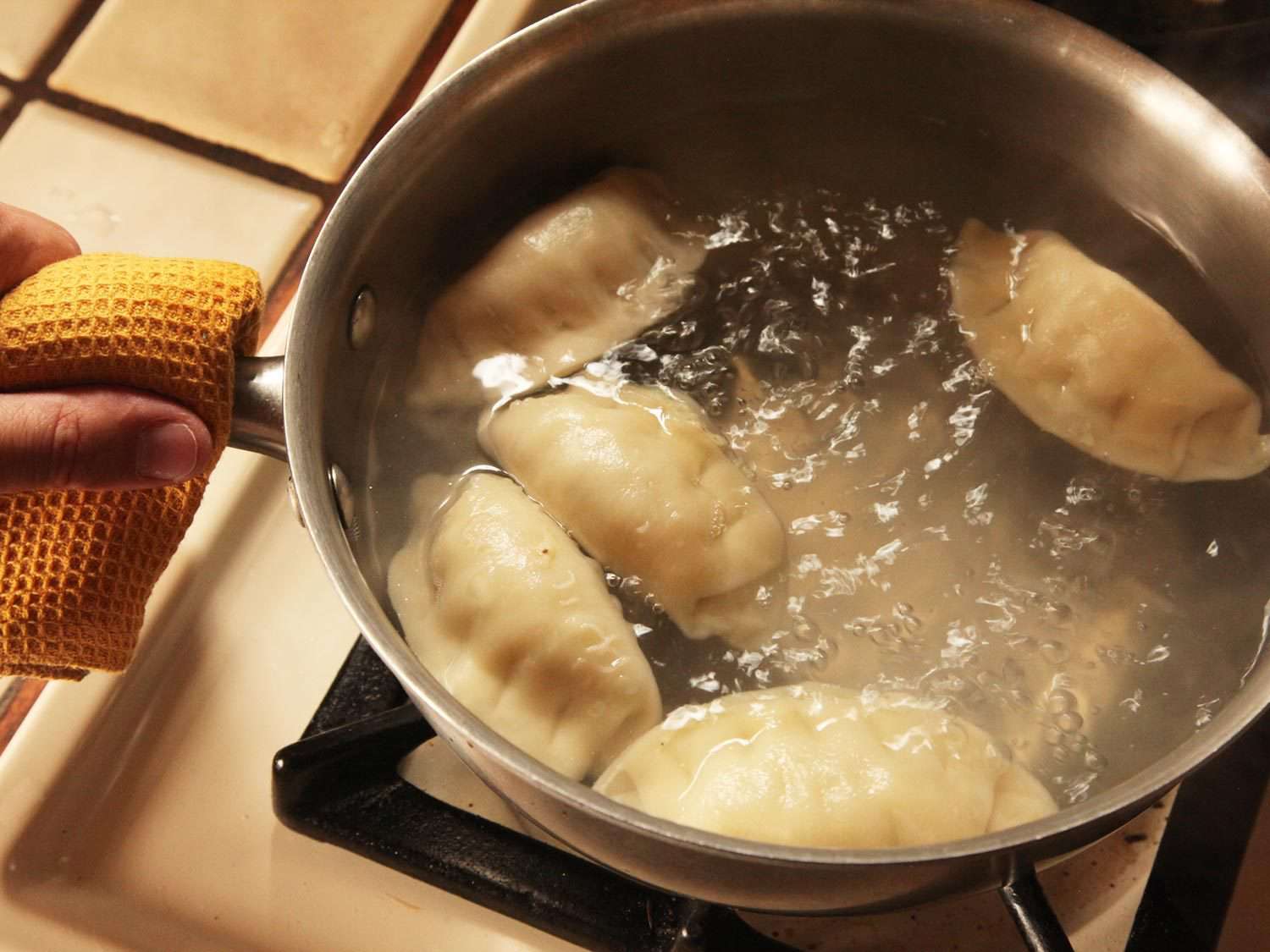 Frozen dumplings in boiling water.