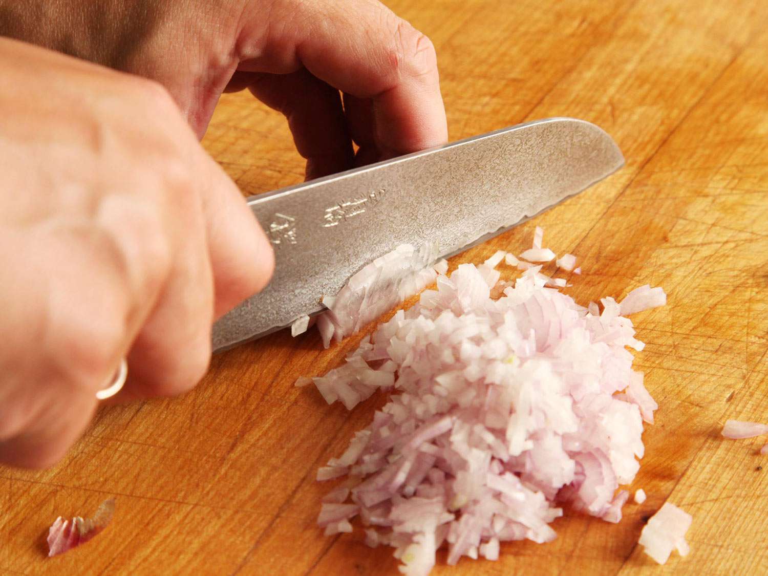 Mincing a shallot with a chef's knife.