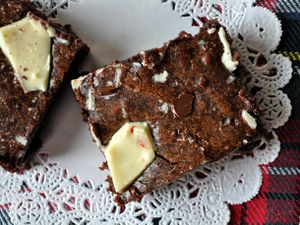 Closeup of a peppermint bark brownie on a paper doily.