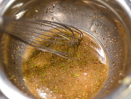 Whisking ingredients for the Greek vinaigrette.