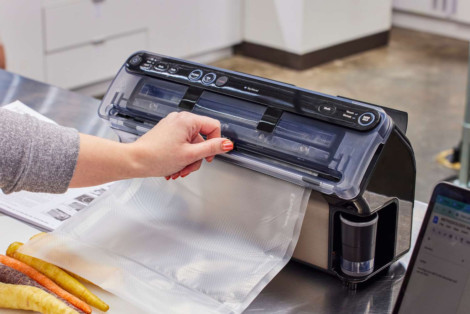 A person adjusts the FoodSaver V4400 2-in-1 Vacuum Sealer Machine bag