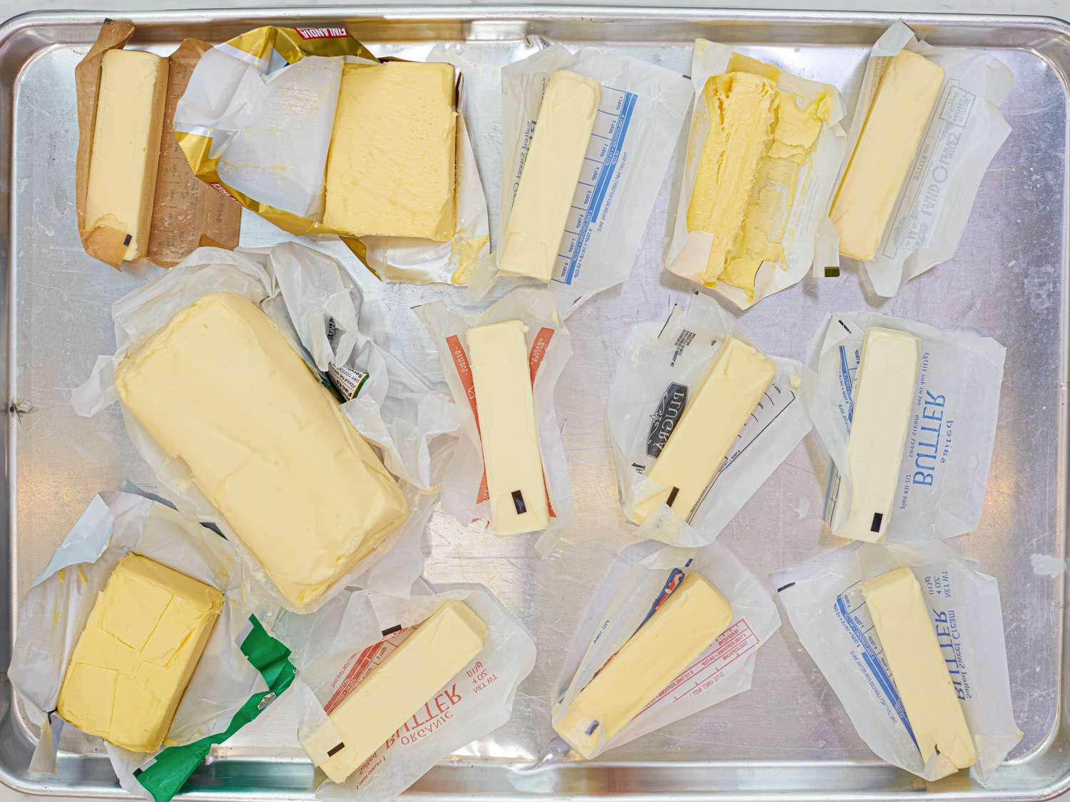 Different butters on a rimmed baking sheet.