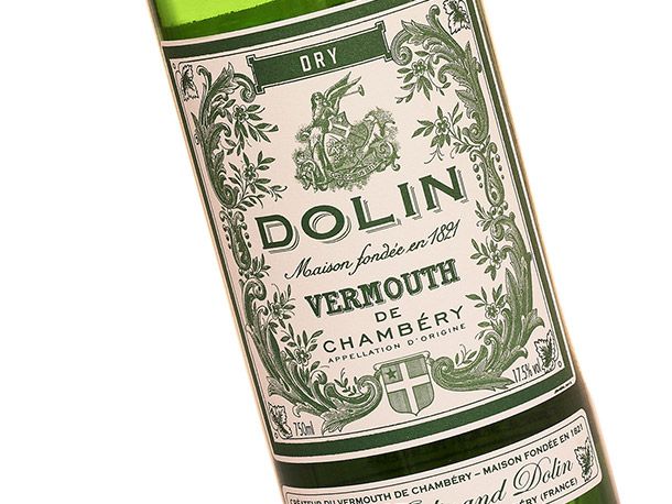 Closeup of a bottle of Dolin dry vermouth with an old-fashioned green and white label.