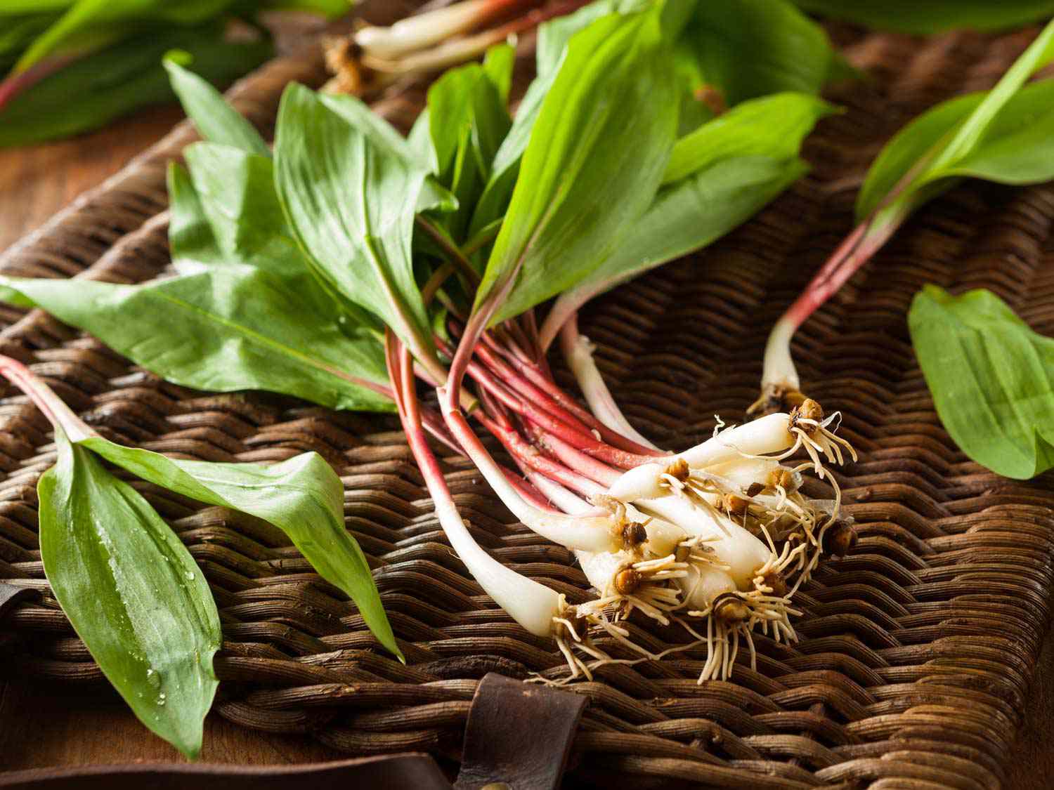 A bunch of ramps on top of a wicker basket. 