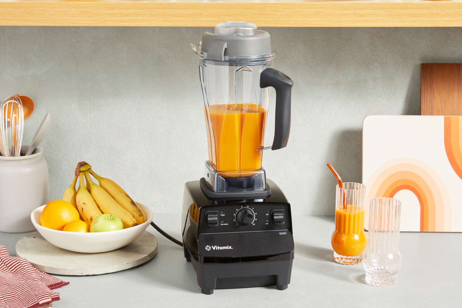 Vitamix 5200 Professional-Grade Blender filled with orange smoothie
