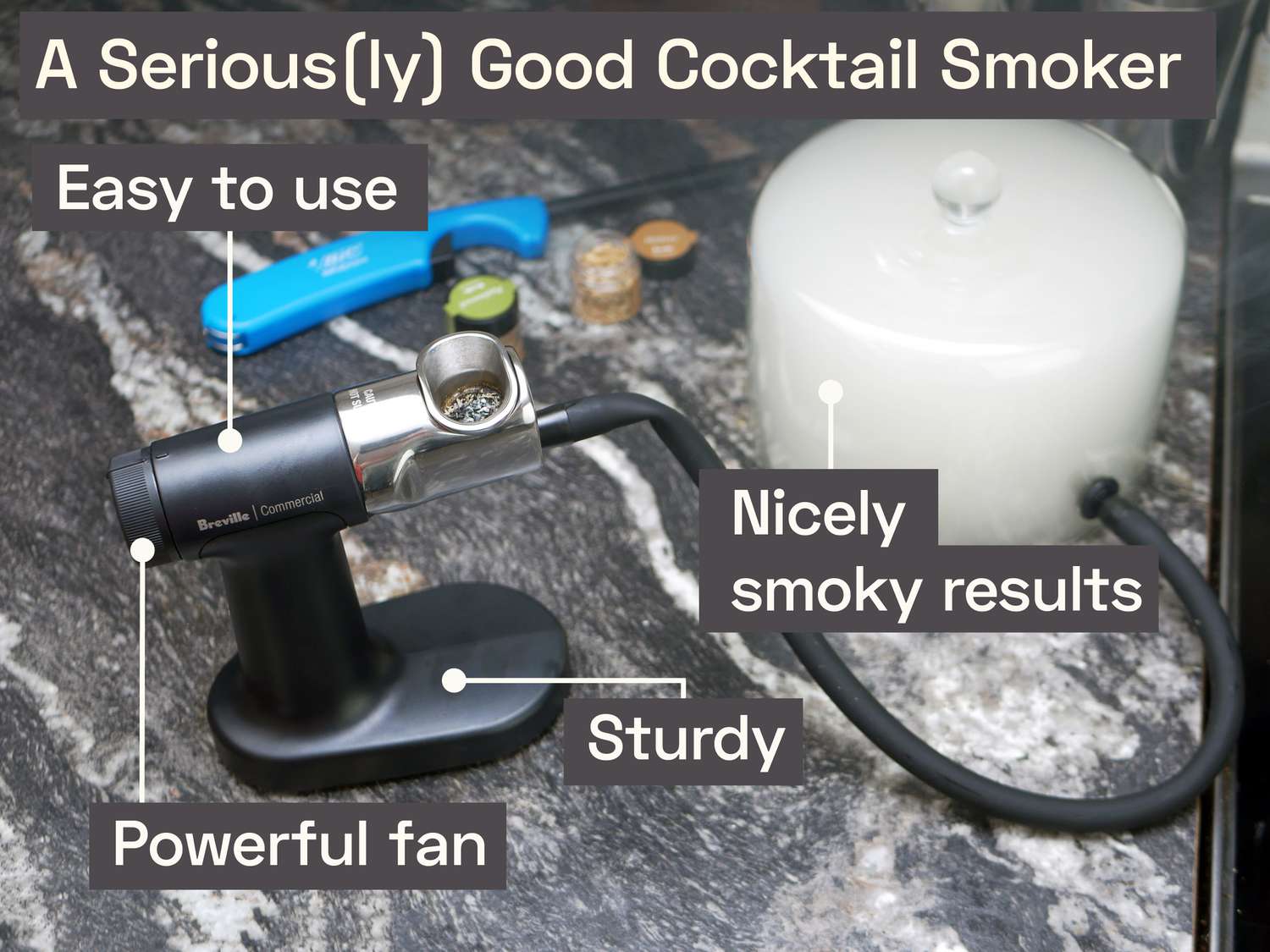 the breville polyscience on a marble countertop with a cloche filled with smoke