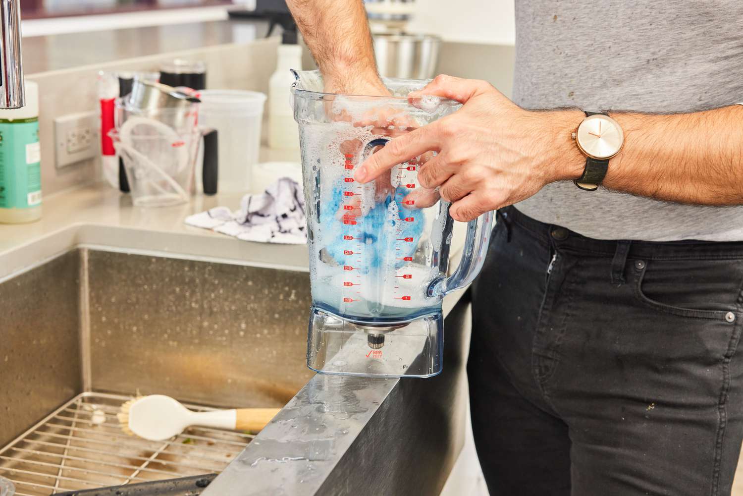 A person washes the Breville Stainless Steel Super Q Blender