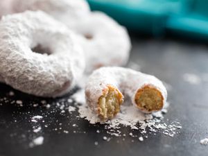 Closeup of homemade mini donettes covered in powdered sugar